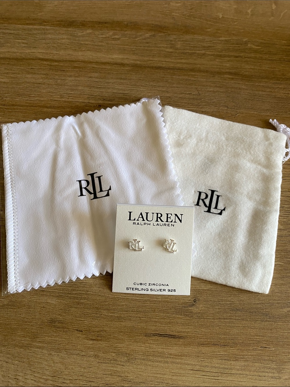 Lauren Ralph Lauren three piece accessory earrings, buffing cloth and bag